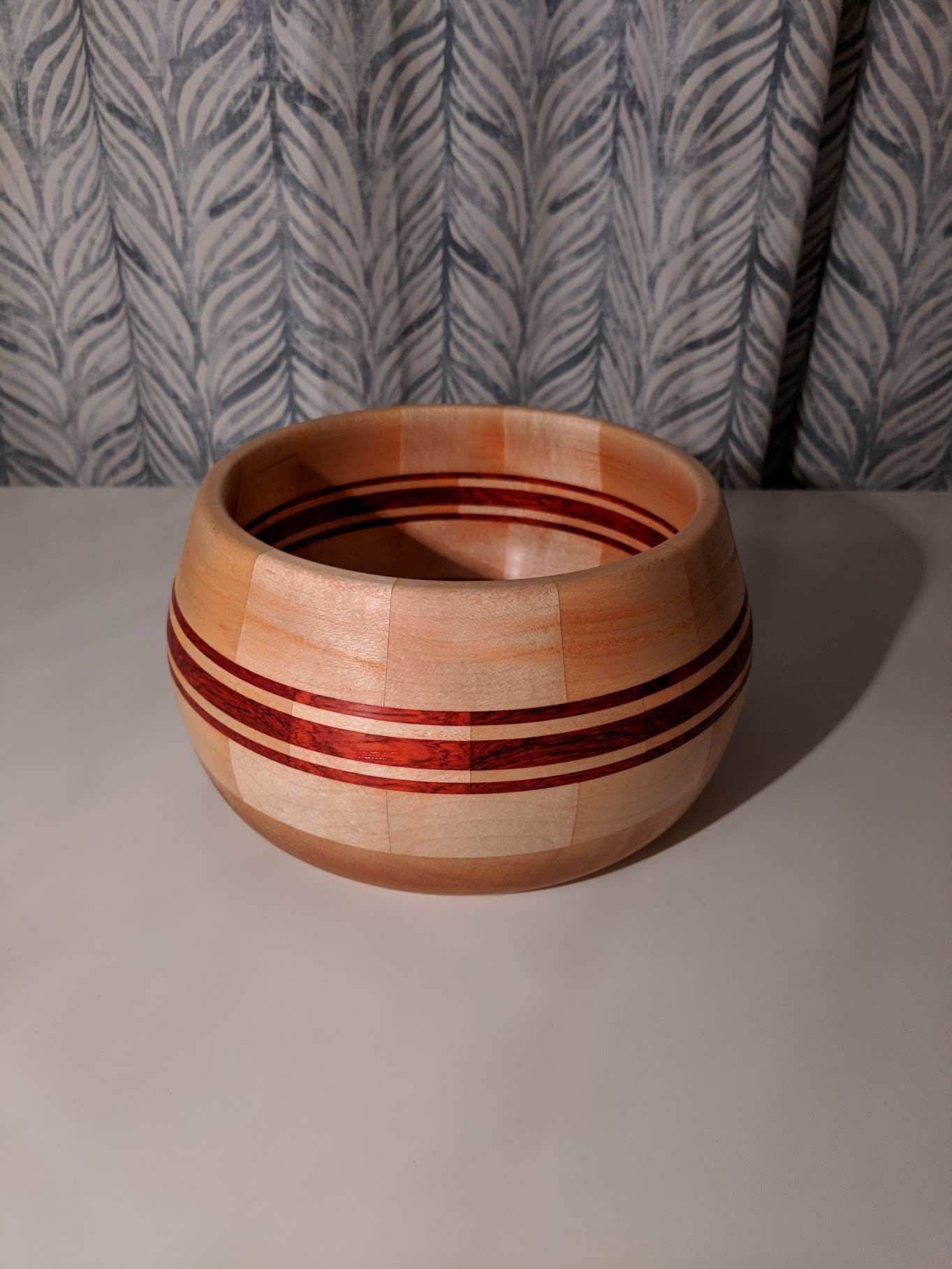 Striped paduak and maple segmented bowl